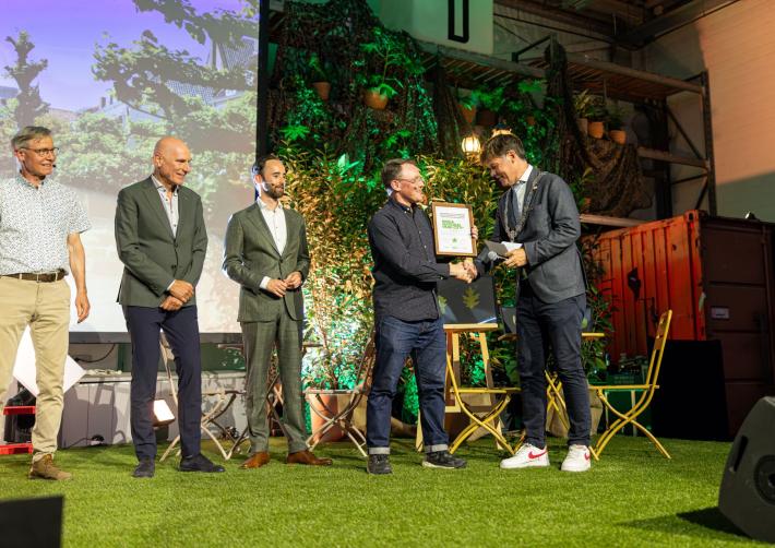 Burgemeester Paul Depla schud een hand tijdens de uitreiking van de titel 'National Park City'